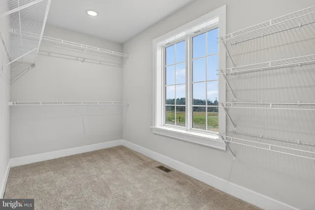 a bedroom with a bed next to a window