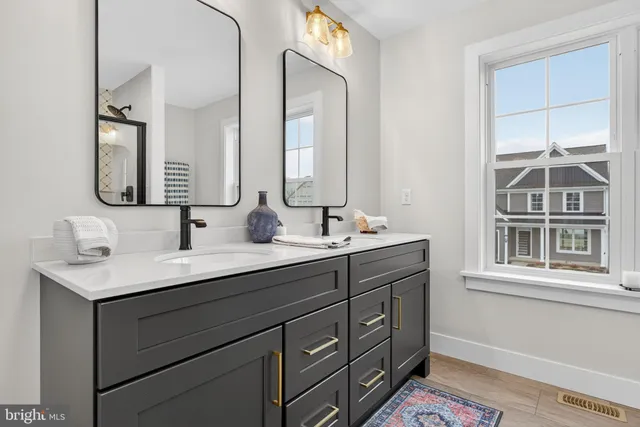 a bedroom with a dresser and a chandelier