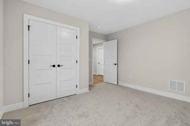 a aerial view of a house with a barbeque and lawn chairs