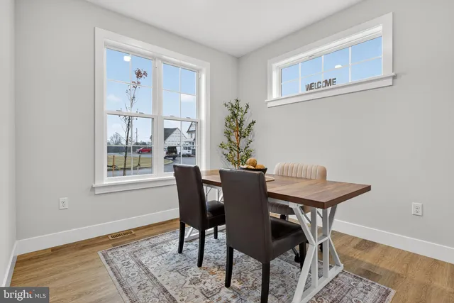 a view of a dining room with furniture and window