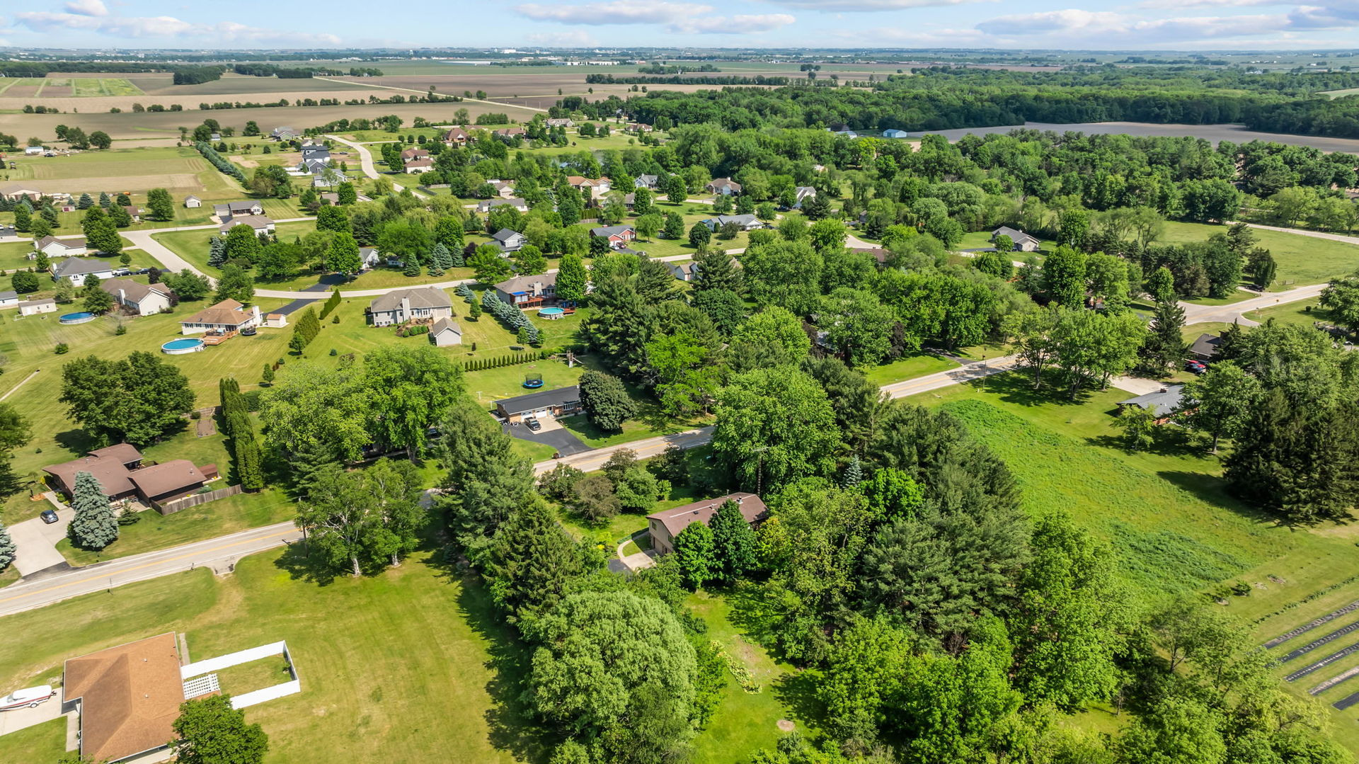 5748 South Skare Road Rochelle, IL 61068 - Photo 42 of 45 an aerial view of residential houses with outdoor space and trees