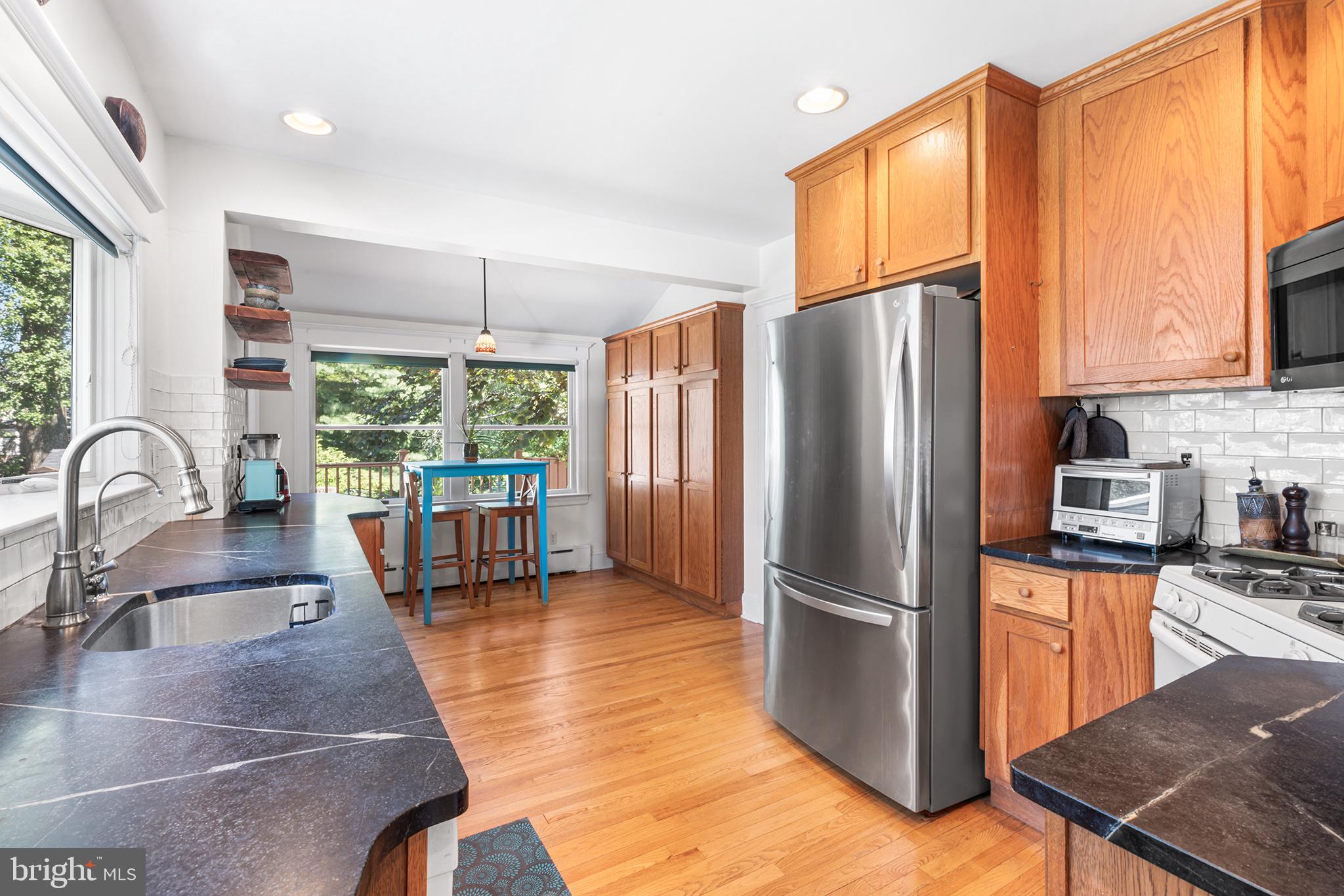 114 Simpson Road Ardmore, PA 19003 - Photo 12 of 37 a kitchen with stainless steel appliances granite countertop a refrigerator sink and cabinets