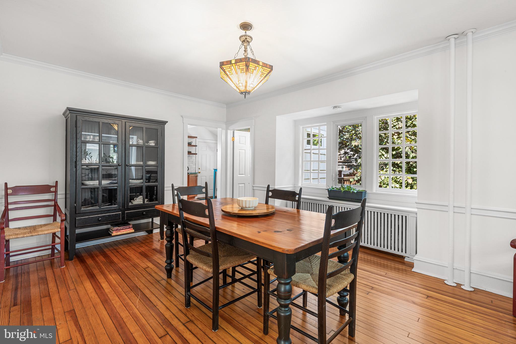114 Simpson Road Ardmore, PA 19003 - Photo 10 of 37 a dining room with wooden floor a chandelier a wooden table and chairs