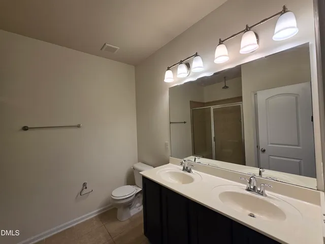a bathroom with a glass shower door