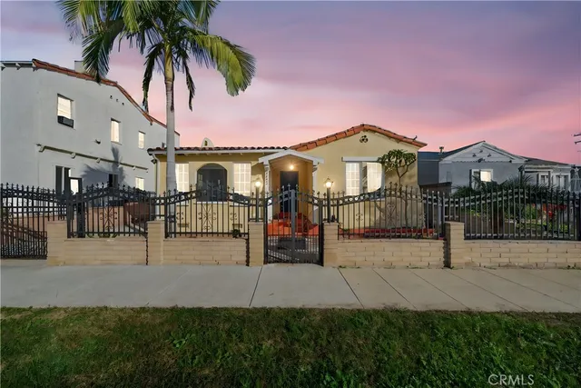 a front view of a house with a garden and plants