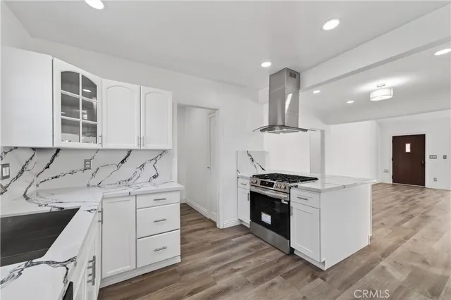 a kitchen with a stove oven and sink