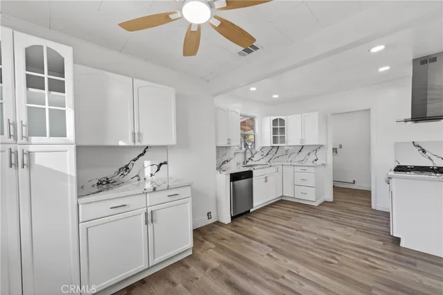 a kitchen with a sink window and cabinets