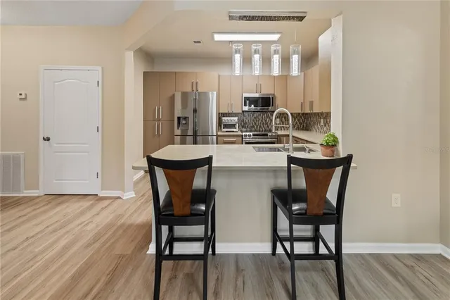 a dining room with furniture and wooden floor