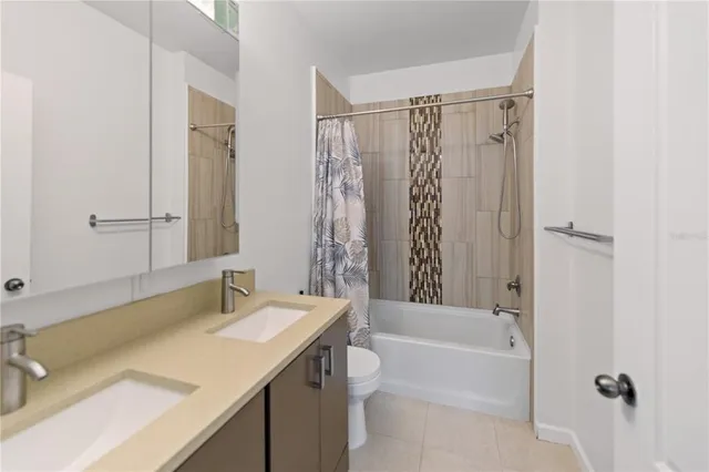 a bathroom with a sink mirror toilet and bathtub