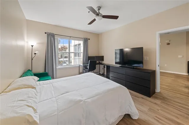 a bedroom with a bed and a flat screen tv