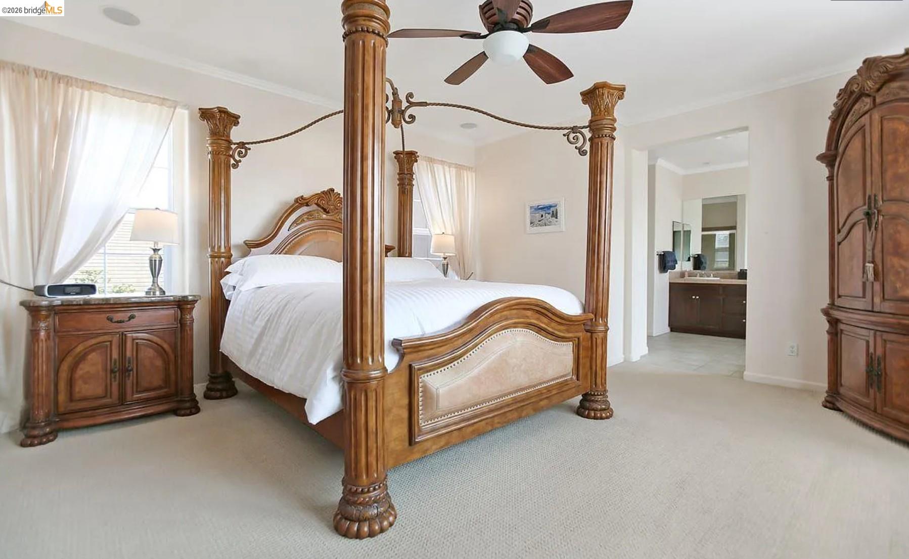 3251 Lookout Point Loop Discovery Bay, CA 94505 - Photo 15 of 31 Bedroom with light carpet, a ceiling fan, multiple windows, ensuite bath, and crown molding