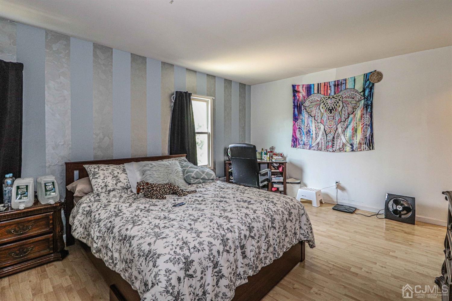 24 Redbud Road Piscataway, NJ 08854 - Photo 20 of 32 a bedroom with a large bed and a chandelier