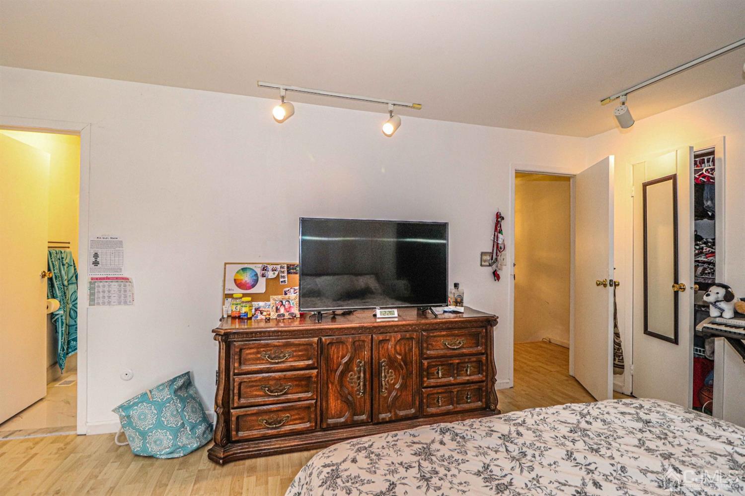 24 Redbud Road Piscataway, NJ 08854 - Photo 22 of 32 a bedroom with a bed and television