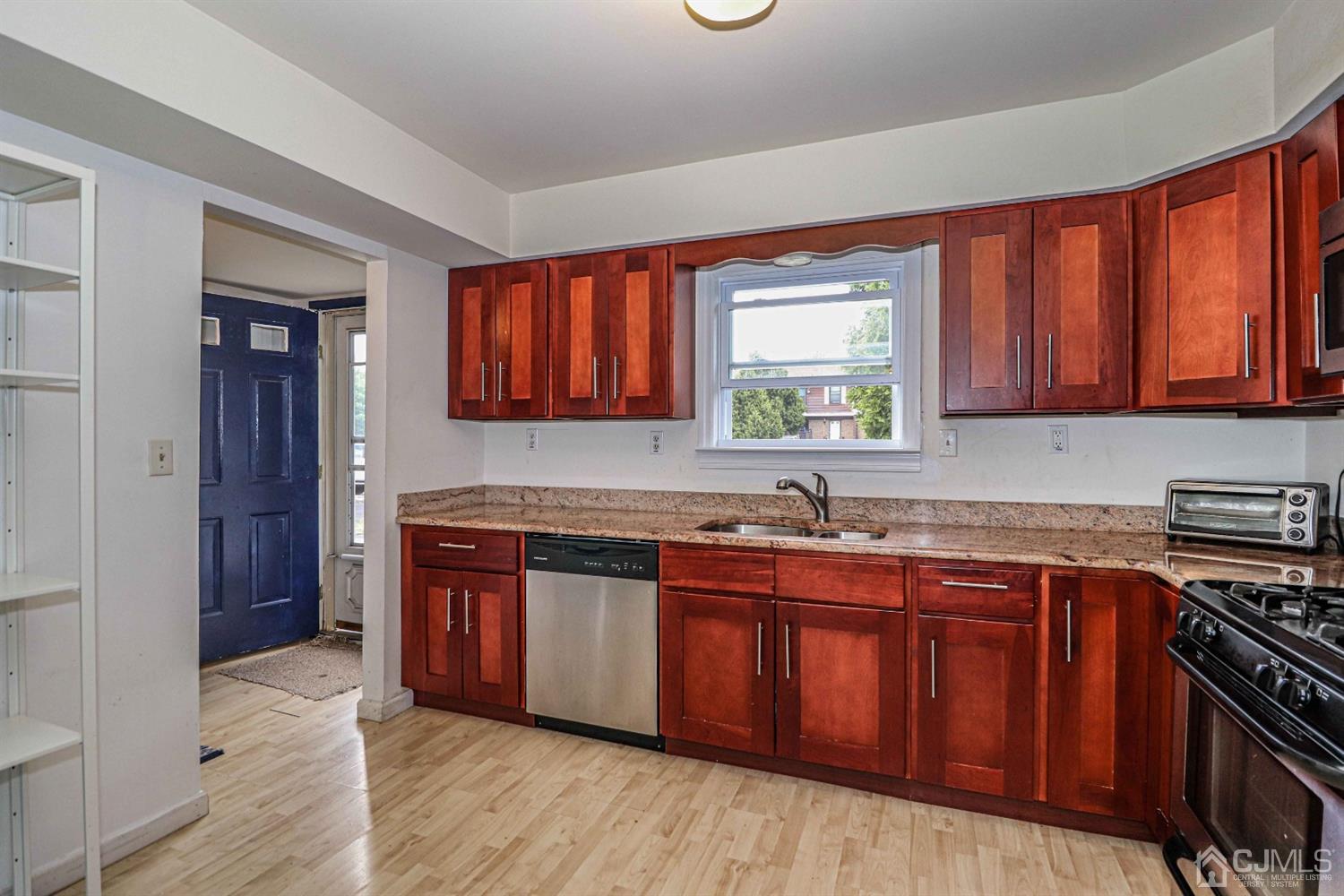 24 Redbud Road Piscataway, NJ 08854 - Photo 4 of 32 a kitchen with stainless steel appliances granite countertop wooden cabinets a sink and a stove