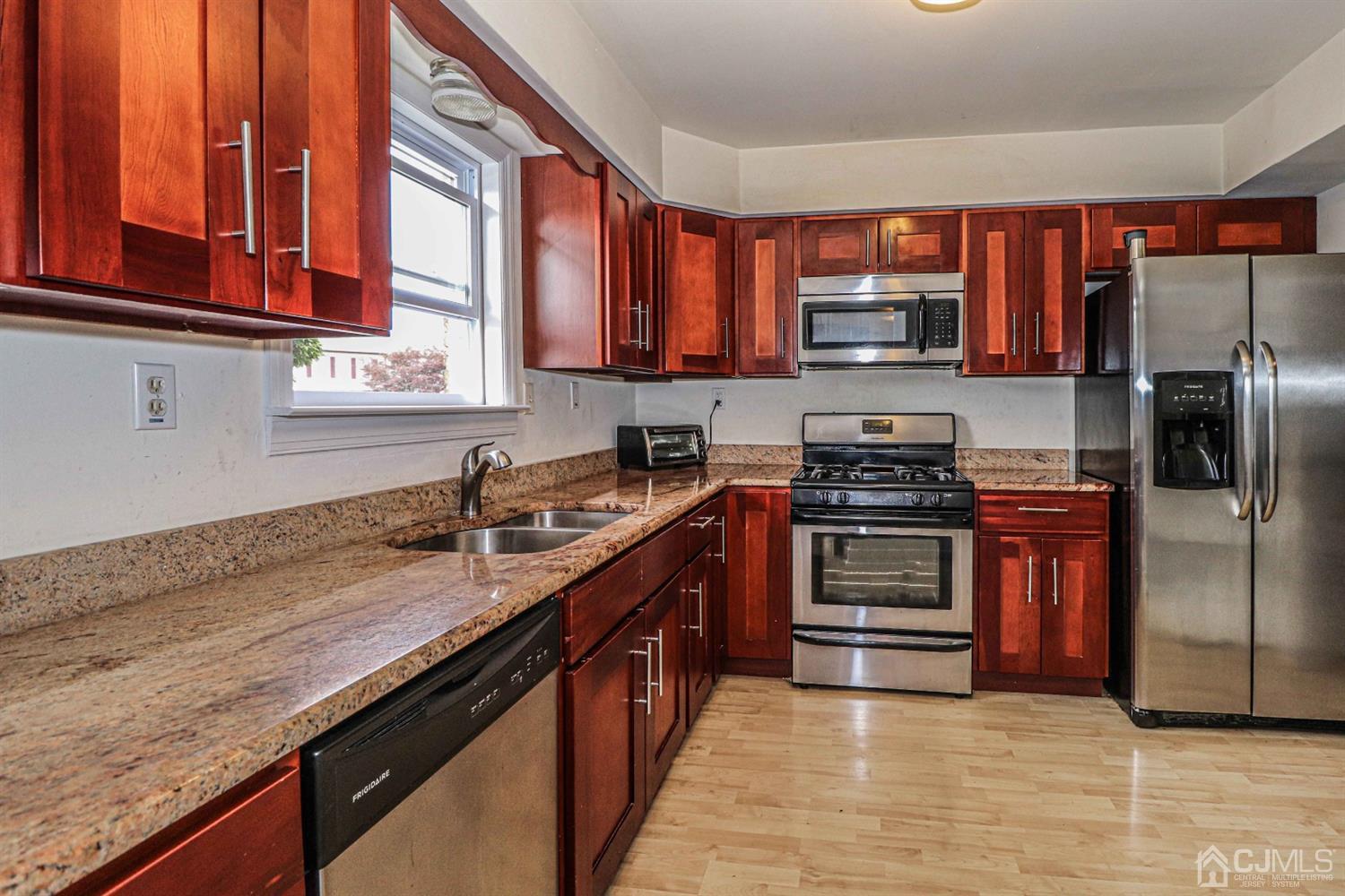 24 Redbud Road Piscataway, NJ 08854 - Photo 5 of 32 a kitchen with stainless steel appliances granite countertop a stove a sink and a microwave