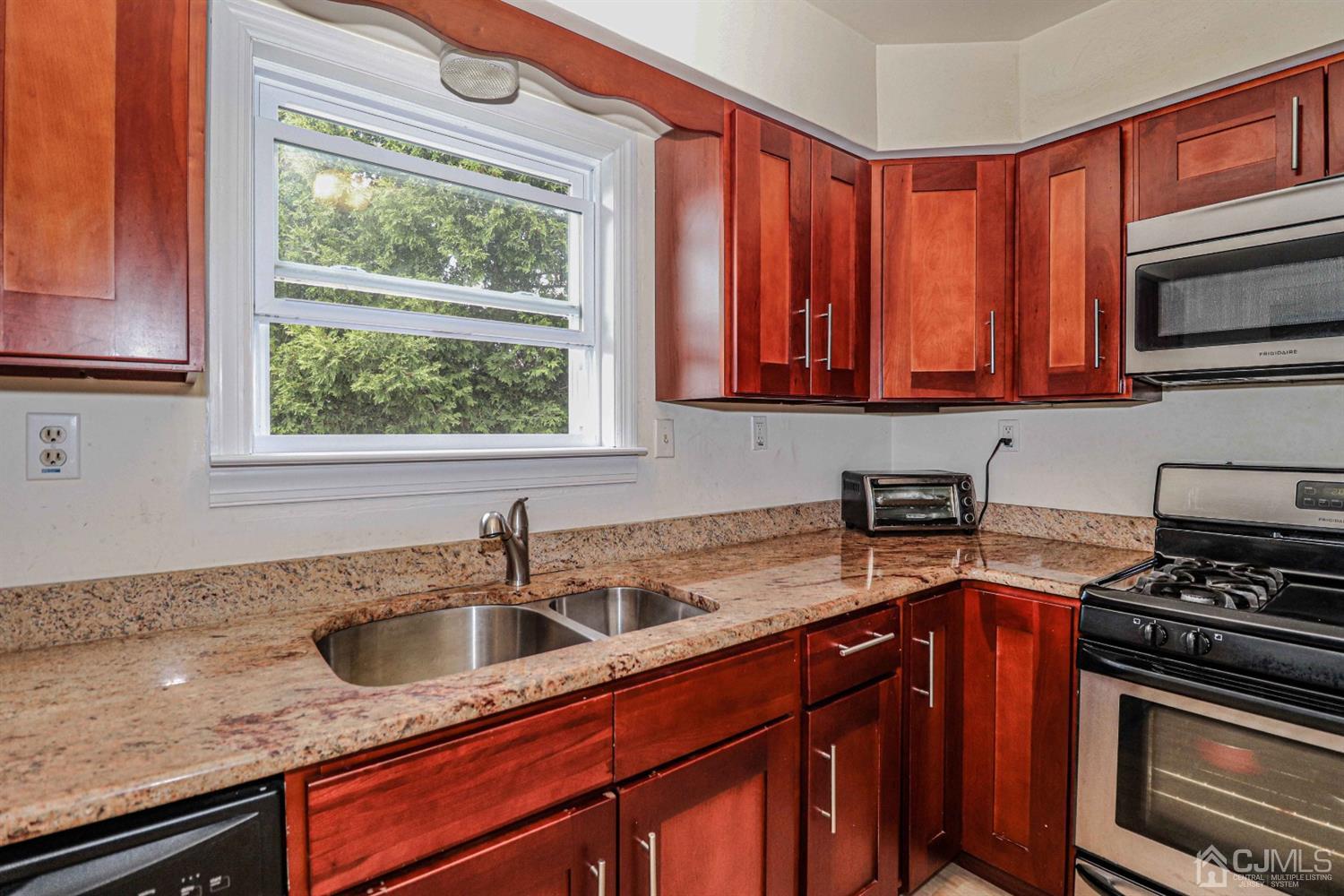 24 Redbud Road Piscataway, NJ 08854 - Photo 10 of 32 a kitchen with stainless steel appliances granite countertop a sink a stove and a microwave