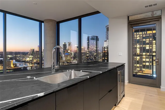a kitchen with a sink and a mirror