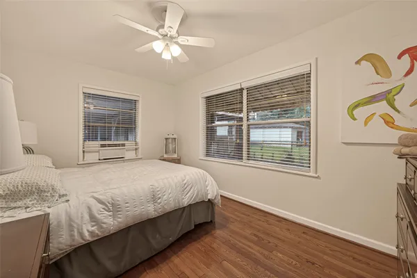 a bedroom with a bed dresser and a window