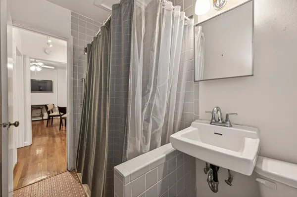 a bathroom with a sink a mirror and a shower
