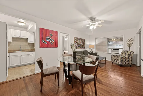 a dining room with furniture and wooden floor