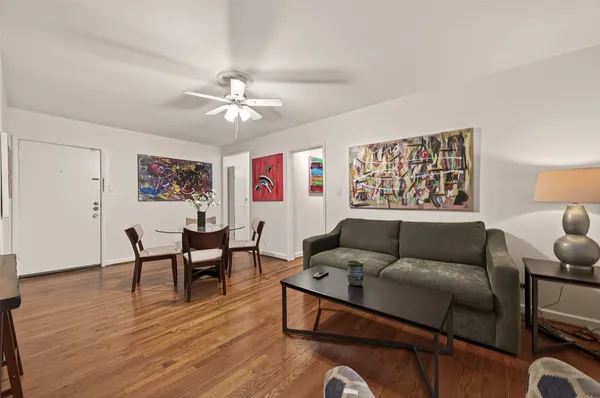 a living room with furniture and a wooden floor