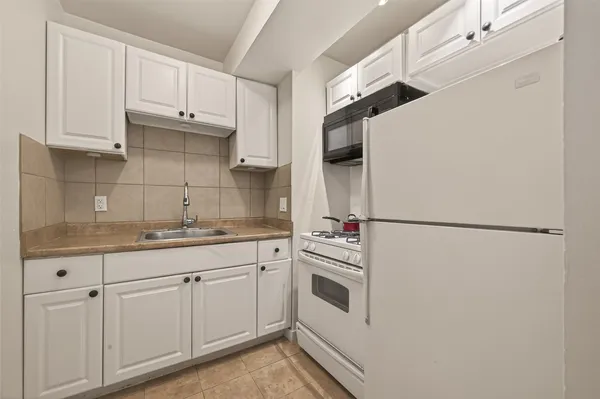 a white refrigerator freezer sitting inside of a kitchen