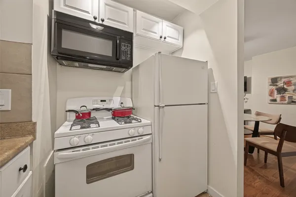 a kitchen with a microwave and a refrigerator