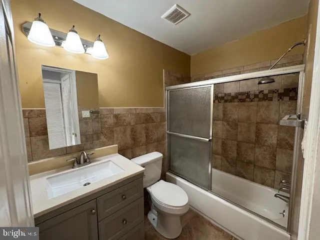 a bathroom with a sink mirror toilet and bathtub