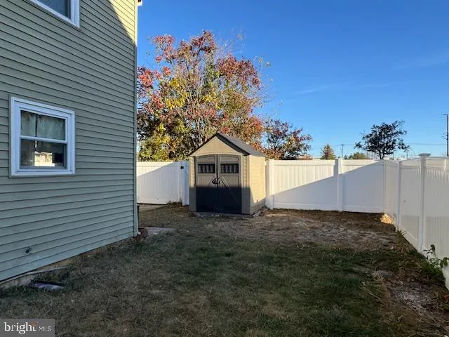 a view of a house with a yard and potted plants