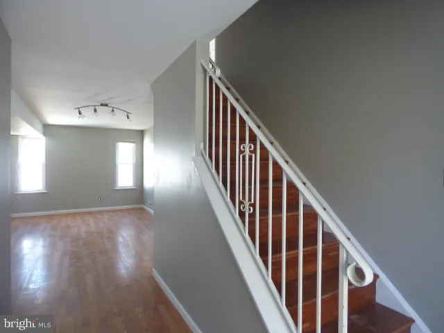 a view of entryway and hall with wooden floor