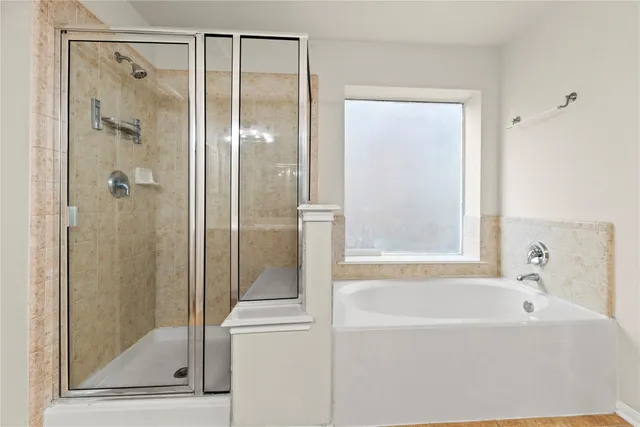 a bathroom with a bathtub and a shower
