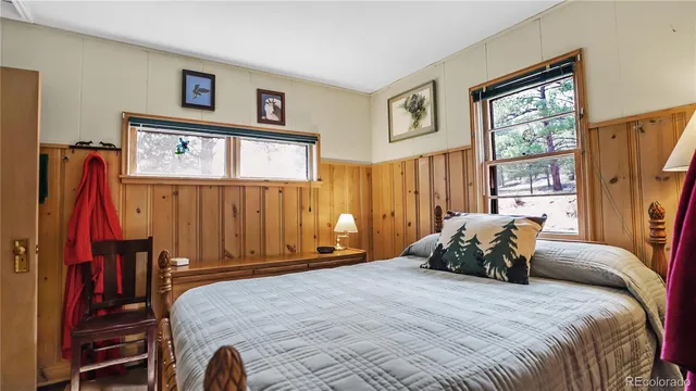 a bedroom with furniture and large windows