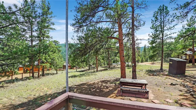 a view of a house with backyard sitting area and garden