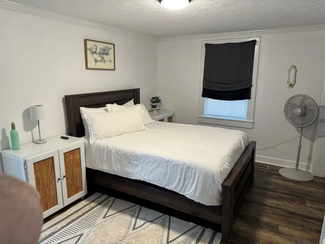 a bedroom with a bed and a chandelier