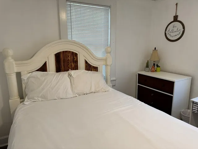 a bedroom with a bed and a closet