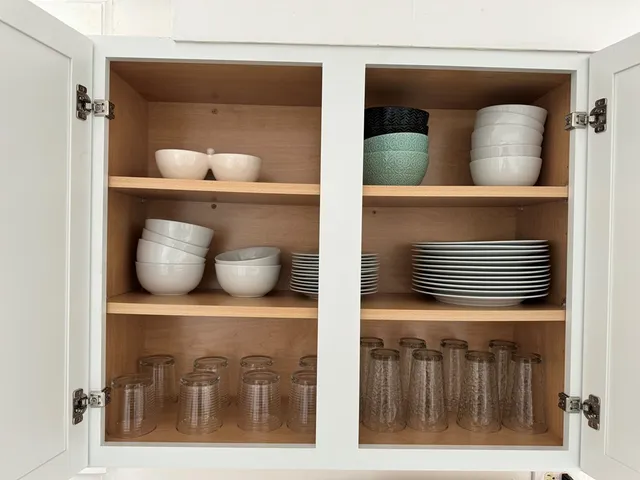 a large bed sitting in a bedroom next to a lamp