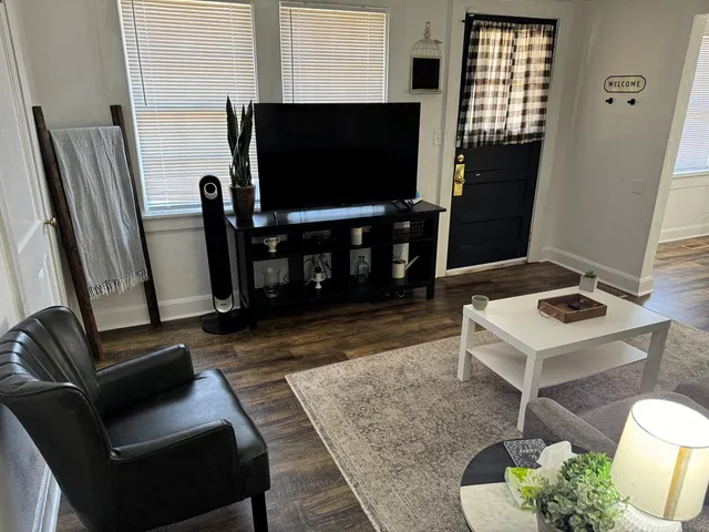 a living room with furniture and a potted plant