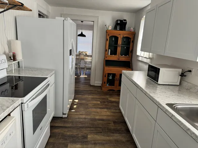 a kitchen with cabinets and wooden floor