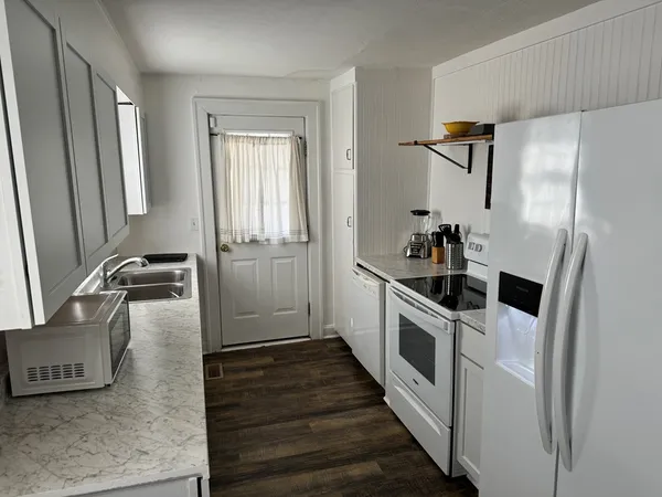 a kitchen with a refrigerator and a sink