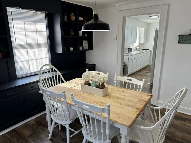a view of a dining room with furniture and window