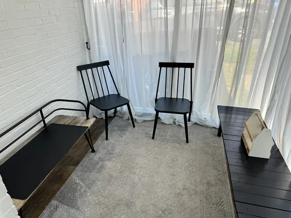 a view of a bedroom with furniture and wooden floor