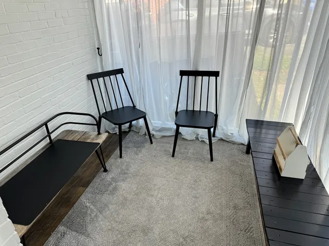 a view of a bedroom with furniture and wooden floor