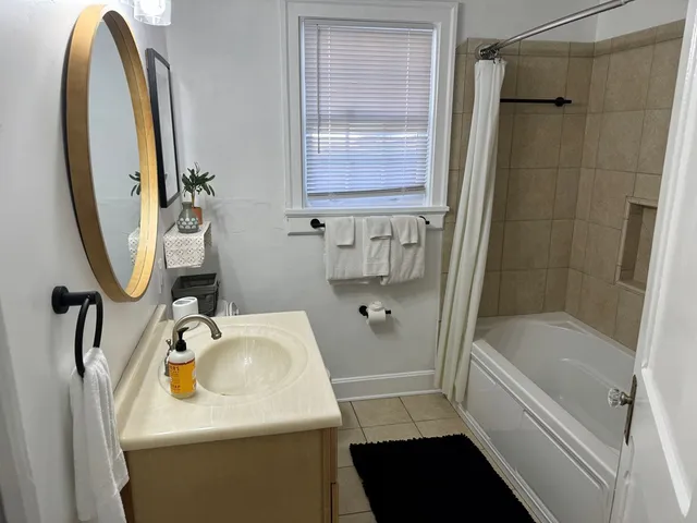 a bathroom with a sink a toilet and a mirror