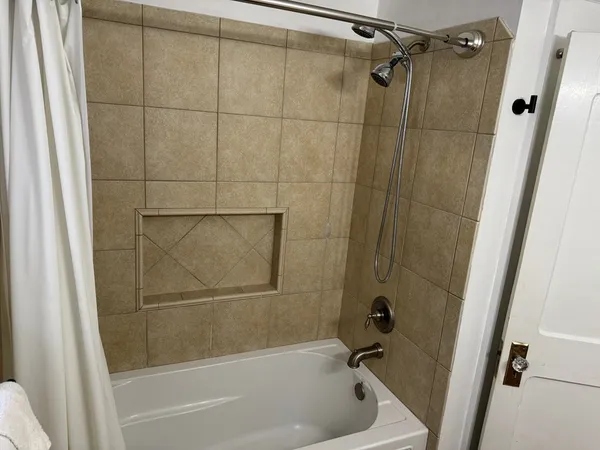 a bathroom with a shower and a bath tub