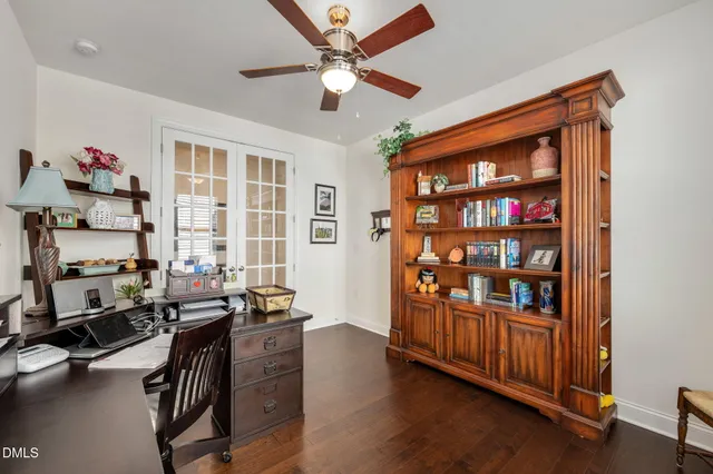 a view of a workspace with furniture and a window