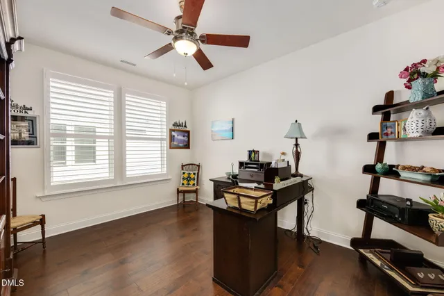 a view of a workspace with furniture and a window