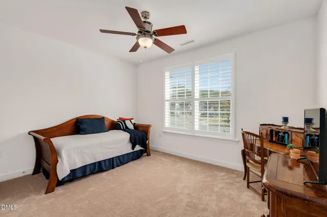a bedroom with furniture and a large window