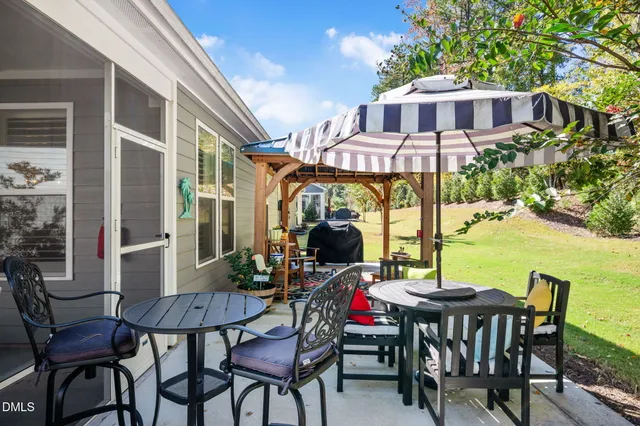 a front view of house with yard patio and outdoor seating