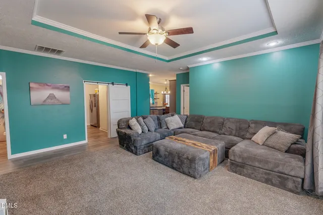 a living room with a bed furniture and a large window