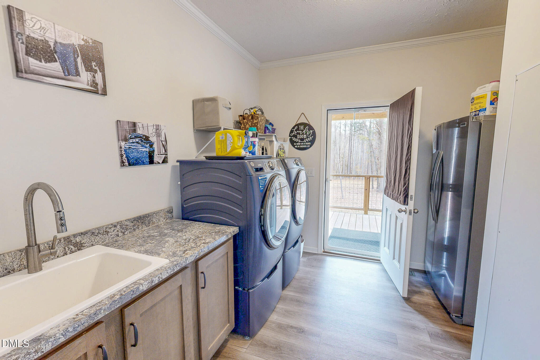 630 Clay Thomas Road Roxboro, NC 27573 - Photo 17 of 46 a utility room with cabinets washer and dryer